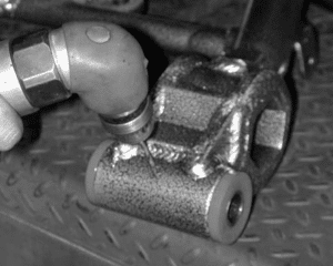 Drilling through bushing and sleeve for grease path
