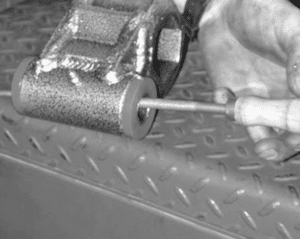 Threading grease fitting into pivot tube