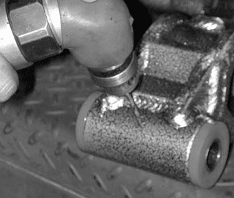 Drilling through the zerk fitting hole on the control arm sleeve