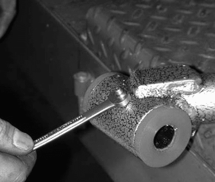 Installing a grease fitting into the control arm pivot