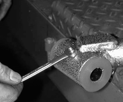 Installing grease fitting into drilled sleeve