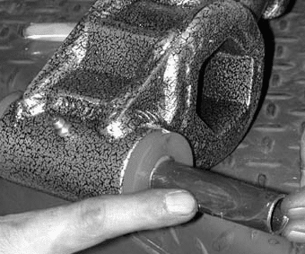Inserting greased inner sleeve into control arm