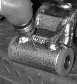 Drilling 1/8 inch hole through bushing and sleeve for grease fitting