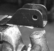 Sway bar bracket held in a vice before bending for alignment