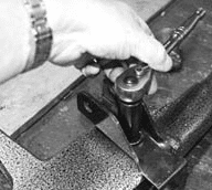 Using a ratchet to crank down sway bar bracket until flush with beam