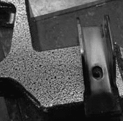 Sway bar bracket after bending showing improved hole alignment