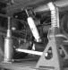 Hydraulic jack placed under rear axle to relieve leaf spring tension
