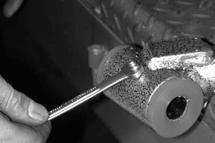 Greasing and inserting inner sleeve into control arm (Fig #10)