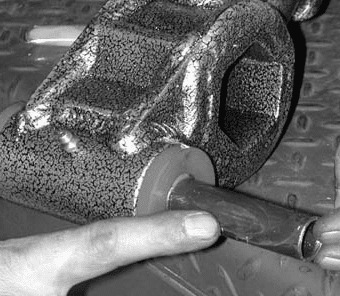 Inserting the greased inner sleeve into the control arm