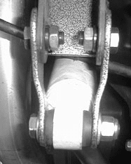 Shock extender bracket installed on the right side axle mount