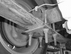 DJM axle locator bracket installed on top of the leaf spring with the rear axle flipped over the spring on a 1973–1987 Chevy C10