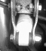 Shock extender bracket bolted over the factory axle shock mount
