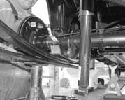 DJM axle locator bracket placed on top of the leaf spring with the offset hole forward