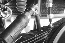 C-clamp holding the leaf spring pack together while the center bolt nut is loosened