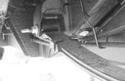 Driver side forward leaf spring bolt left in place near the gas tank
